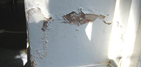 rising damp causing flaking paint and plaster